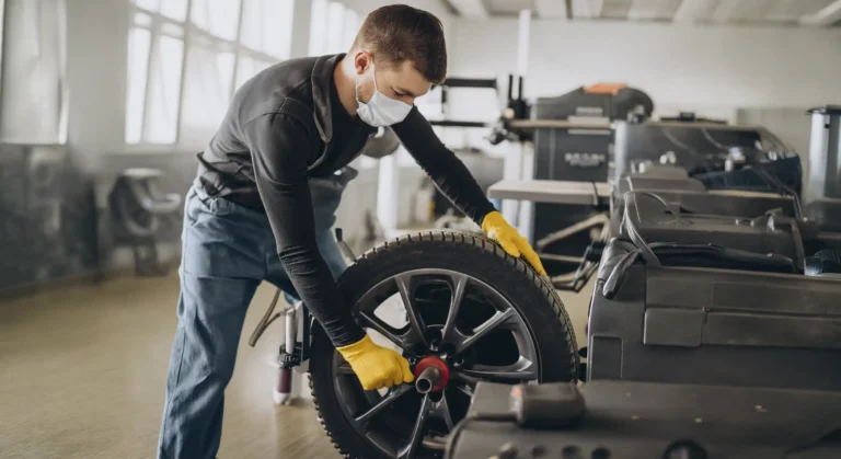Technician refinishing an alloy wheel