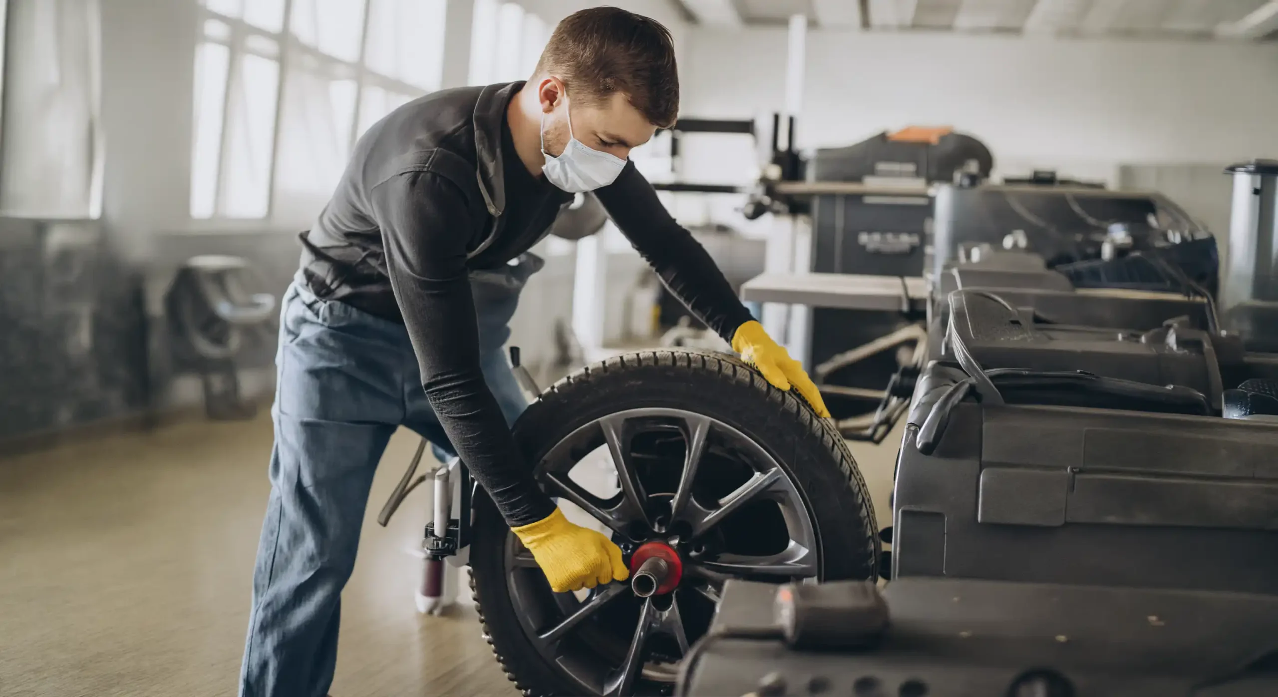 Technician refinishing an alloy wheel